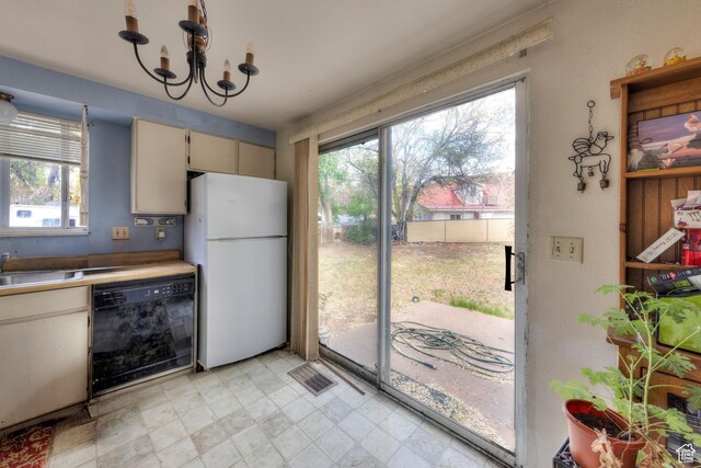 451 & Dr, Moab, UT 84532 - kitchen with a healthy amount of sunlight, a sink, dishwasher, and freestanding refrigerator