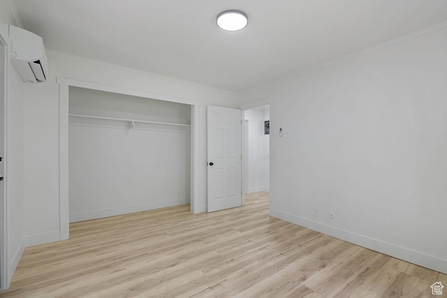 210 Ogden Cyn, Ogden, UT 84401 - unfurnished bedroom with baseboards, a wall mounted AC, a closet, crown molding, and light wood-type flooring
