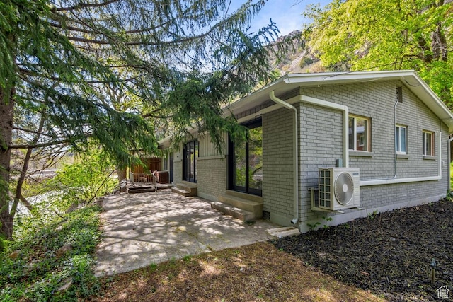 208 Ogden Cyn, Ogden, UT 84401 - view of side of property with ac unit, a patio area, brick siding, and entry steps