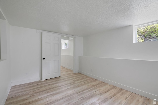 208 Ogden Cyn, Ogden, UT 84401 - unfurnished room with baseboards, a textured ceiling, and wood finished floors