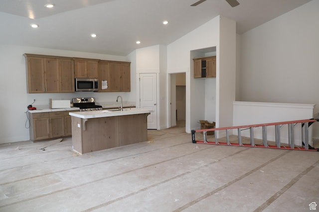 3719 N Janie St Unit 1014, Eagle Mountain, UT 84005 - kitchen featuring a kitchen island with sink, a sink, stainless steel appliances, light countertops, and vaulted ceiling