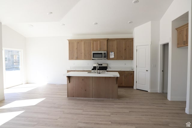 3719 N Janie St Unit 1014, Eagle Mountain, UT 84005 - kitchen with stainless steel microwave, light countertops, light wood-style flooring, a center island with sink, and vaulted ceiling