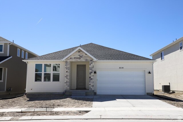 3719 N Janie St Unit 1014, Eagle Mountain, UT 84005 - view of front of house featuring an attached garage, concrete driveway, and a shingled roof