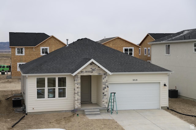 3719 N Janie St Unit 1014, Eagle Mountain, UT 84005 - single story home with stone siding, central AC, concrete driveway, an attached garage, and a shingled roof