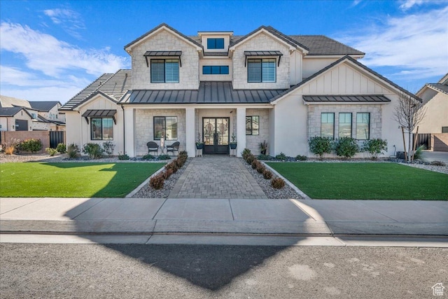2904 E Stonedale Dr, St George, UT 84790 - view of front of property featuring a front lawn, french doors, metal roof, stone siding, and a standing seam roof