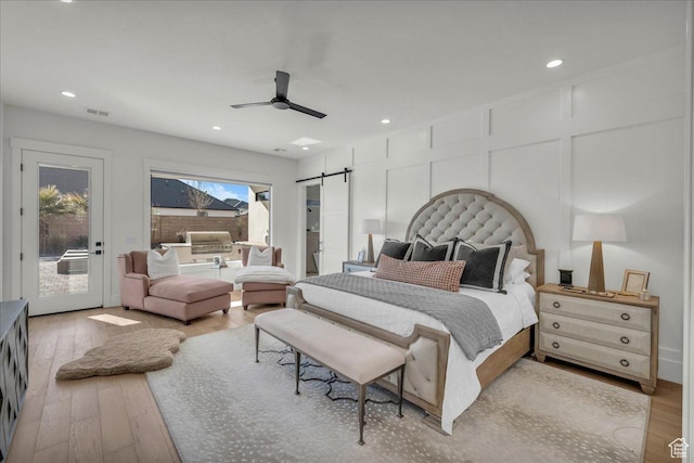 2904 E Stonedale Dr, St George, UT 84790 - bedroom with access to exterior, a decorative wall, a barn door, and light wood-style flooring