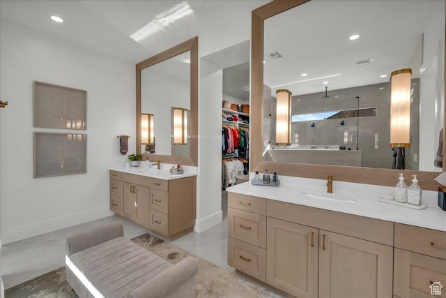 2904 E Stonedale Dr, St George, UT 84790 - bathroom featuring tiled shower, two vanities, recessed lighting, a sink, and a walk in closet