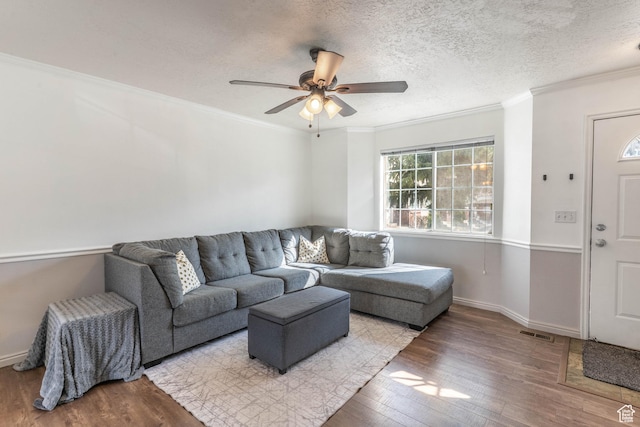 1101 S 900 E Unit 212, Provo, UT 84606 - living area with visible vents, a ceiling fan, a textured ceiling, wood finished floors, and crown molding
