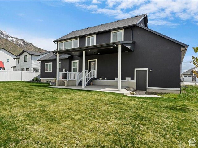 170 W 825 S, Willard, UT 84340 - back of property with fence, stucco siding, a lawn, covered porch, and a mountain view