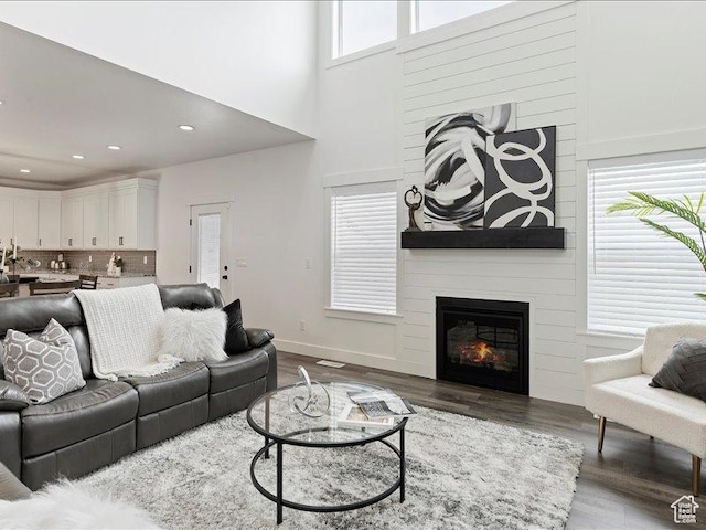 170 W 825 S, Willard, UT 84340 - living room with a large fireplace, baseboards, recessed lighting, a high ceiling, and wood finished floors