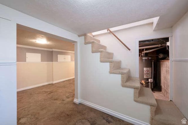 771 E Belmont Ave, Salt Lake City, UT 84105 - below grade area with stairway, gas water heater, a textured ceiling, and baseboards