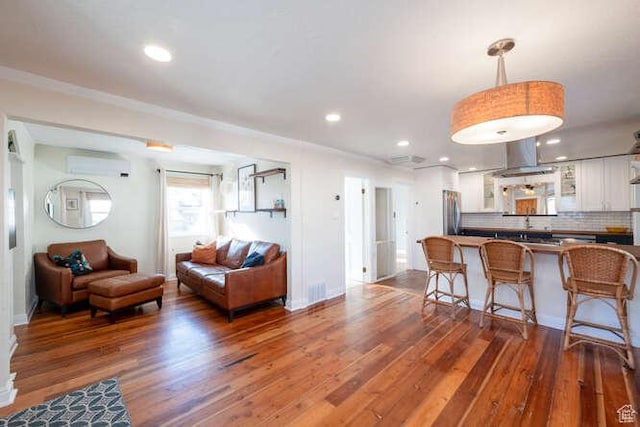 771 E Belmont Ave, Salt Lake City, UT 84105 - living room with recessed lighting, a wall unit AC, and wood finished floors