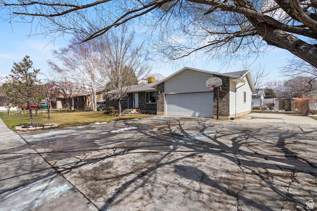 view of front facade with fence, concrete driveway, a front yard, a garage, and a chimney