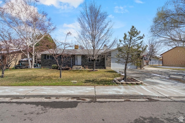 view of front of home with a chimney, a front yard, an attached garage, and driveway