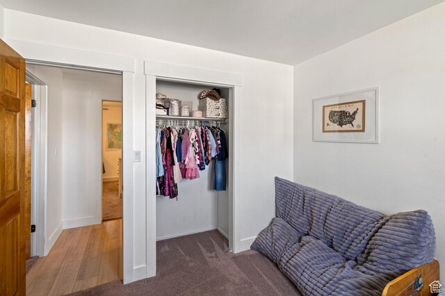 living area with baseboards and light carpet