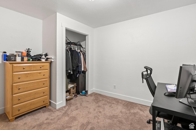 office featuring baseboards and light carpet