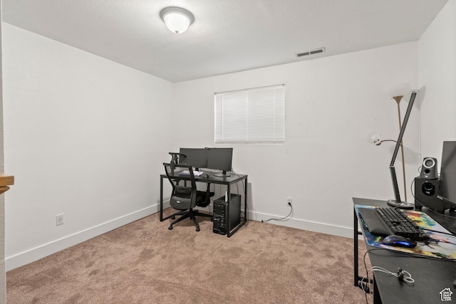 office space featuring visible vents, carpet flooring, and baseboards