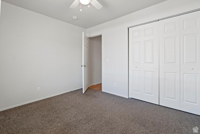 unfurnished bedroom with a closet, baseboards, carpet, and a ceiling fan