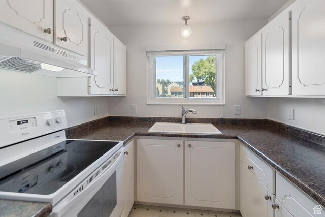 kitchen with under cabinet range hood, a sink, white cabinetry, and white electric range oven