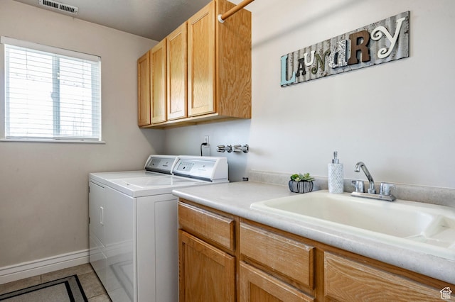 laundry room featuring baseboards, visible vents, separate washer and dryer, cabinet space, and a sink