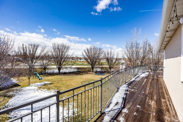 deck featuring a lawn and a playground
