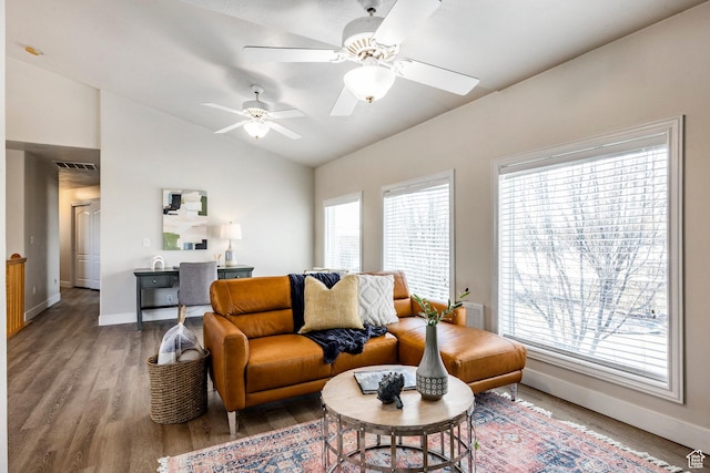 living area with plenty of natural light, light wood-type flooring, ceiling fan, and vaulted ceiling