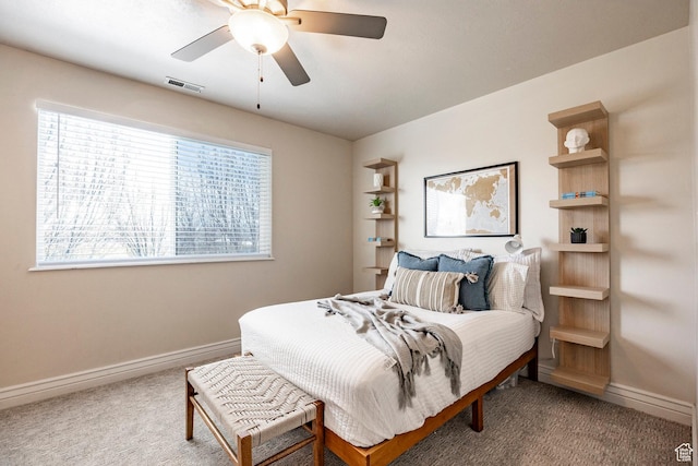 bedroom featuring visible vents, baseboards, carpet floors, and a ceiling fan