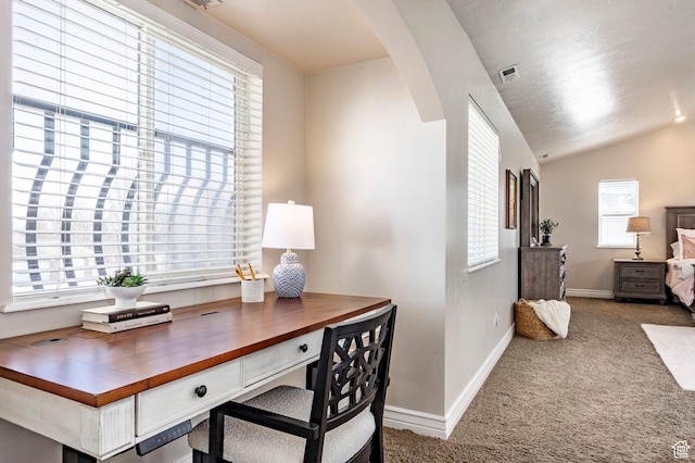 carpeted office featuring baseboards, arched walkways, and vaulted ceiling