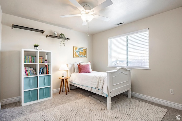 carpeted bedroom featuring visible vents, baseboards, and ceiling fan