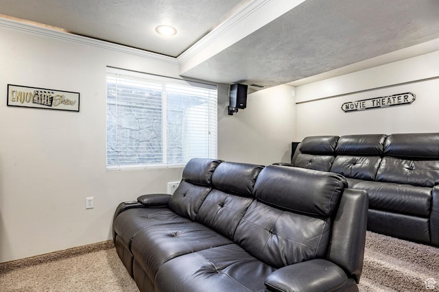 home theater with a textured ceiling, carpet, baseboards, and ornamental molding