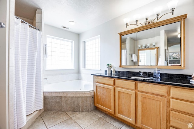full bathroom with vanity, visible vents, tiled tub, tile patterned flooring, and curtained shower