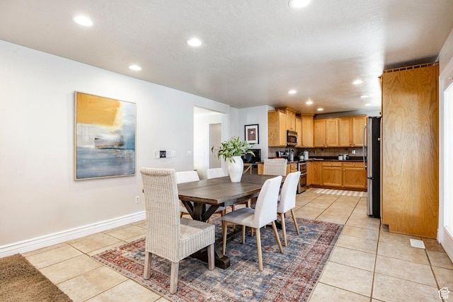 dining space with light tile patterned floors and recessed lighting
