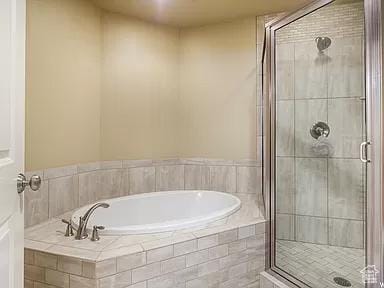 full bath with a bath and a stall shower