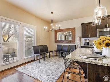 dining space featuring a notable chandelier and wood finished floors