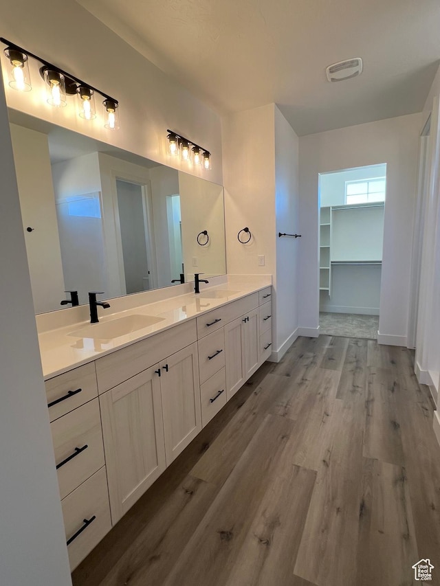 5166 N 2525 W Unit 16, Cedar City, UT 84721 - full bathroom with visible vents, a sink, wood finished floors, and double vanity