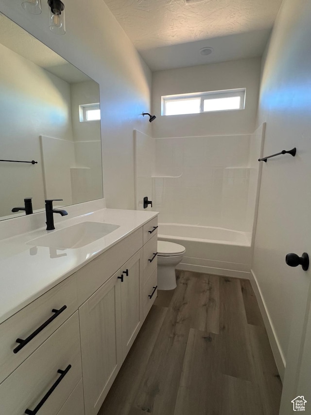 5166 N 2525 W Unit 16, Cedar City, UT 84721 - full bath with vanity, wood finished floors, toilet, baseboards, and shower / bathing tub combination