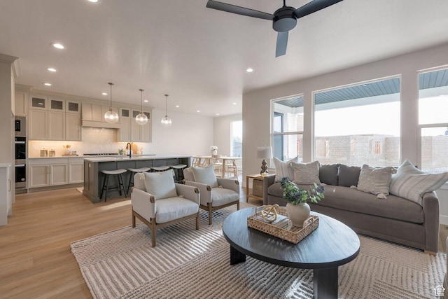 2123 N 520 W, Centerville, UT 84014 - living room with light wood-style floors, a ceiling fan, and recessed lighting