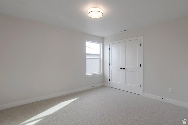 2123 N 520 W, Centerville, UT 84014 - unfurnished bedroom featuring a closet, baseboards, light colored carpet, and visible vents