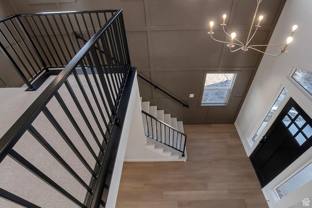 2123 N 520 W, Centerville, UT 84014 - foyer entrance featuring a towering ceiling, wood finished floors, stairway, baseboards, and an inviting chandelier