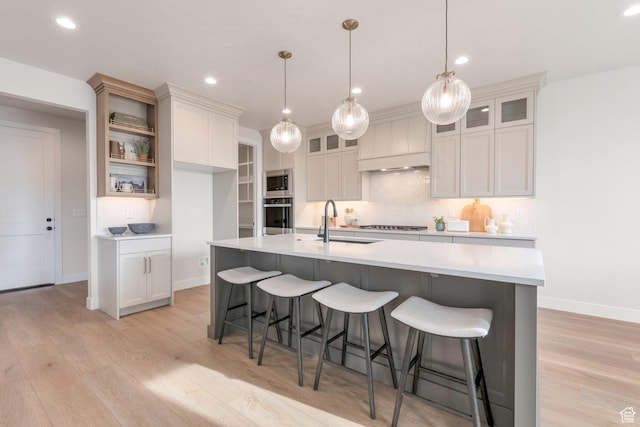 2123 N 520 W, Centerville, UT 84014 - kitchen with a sink, baseboards, light countertops, stainless steel appliances, and light wood-style flooring