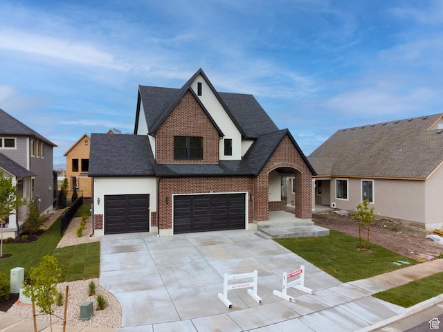 2123 N 520 W, Centerville, UT 84014 - view of front of home featuring brick siding, a front lawn, roof with shingles, and driveway
