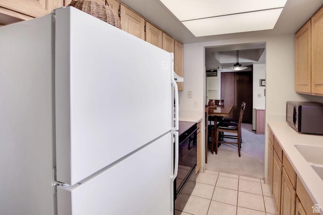 7065 N 2200 W Unit 2W, Summit Park, UT 84098 - kitchen featuring light tile patterned floors, light brown cabinets, freestanding refrigerator, light countertops, and black microwave