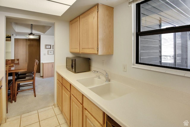 7065 N 2200 W Unit 2W, Summit Park, UT 84098 - kitchen featuring black microwave, light brown cabinetry, light countertops, light tile patterned floors, and a sink