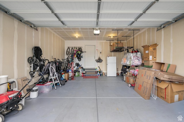 1027 E Reef Dr, Saratoga Springs, UT 84045 - garage featuring freestanding refrigerator