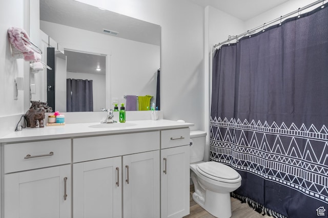 1027 E Reef Dr, Saratoga Springs, UT 84045 - bathroom with visible vents, toilet, a shower with shower curtain, wood finished floors, and vanity