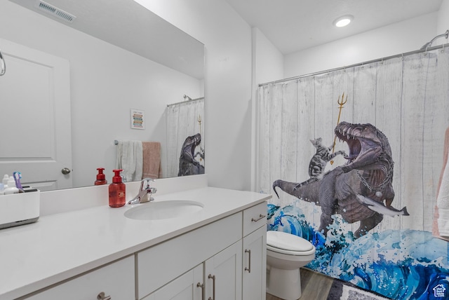 1027 E Reef Dr, Saratoga Springs, UT 84045 - full bathroom with vanity, toilet, wood finished floors, and visible vents