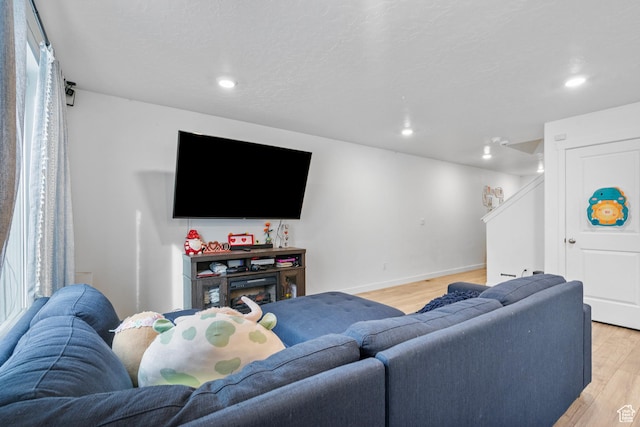 1027 E Reef Dr, Saratoga Springs, UT 84045 - living area featuring recessed lighting, baseboards, stairs, and light wood finished floors