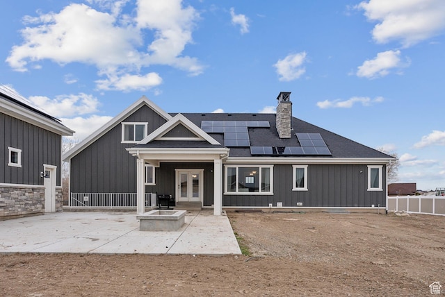 9227 N Horizon Dr, Eagle Mountain, UT 84005 - rear view of house with a patio, french doors, board and batten siding, and roof mounted solar panels