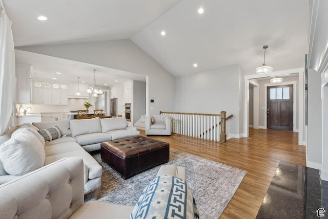 9227 N Horizon Dr, Eagle Mountain, UT 84005 - living area featuring recessed lighting, baseboards, high vaulted ceiling, and light wood-style flooring