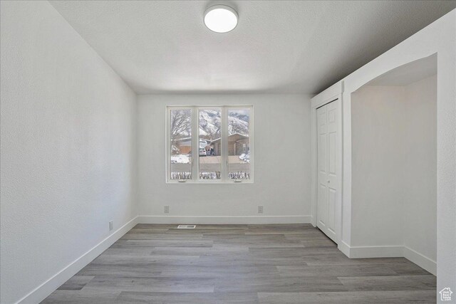 7046 S 2955 E, Cottonwood Heights, UT 84121 - empty room featuring visible vents, baseboards, wood finished floors, and a textured ceiling